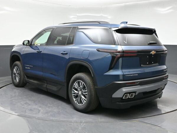 Blue Chevrolet Traverse SUV photographed from a rear-side angle, showing taillights, roof rails, and Chevrolet emblem on the tailgate a