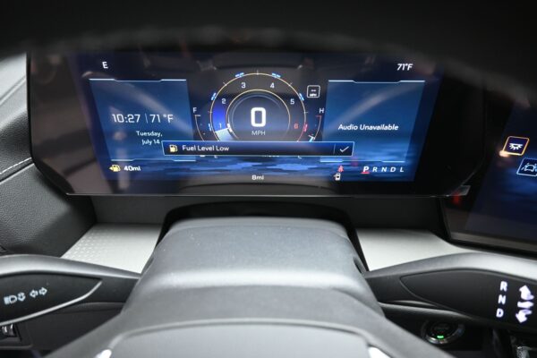 Digital instrument cluster showing fuel level low, 0 mph readout, time 10:27, outside temp 71°F, and 40-mile range