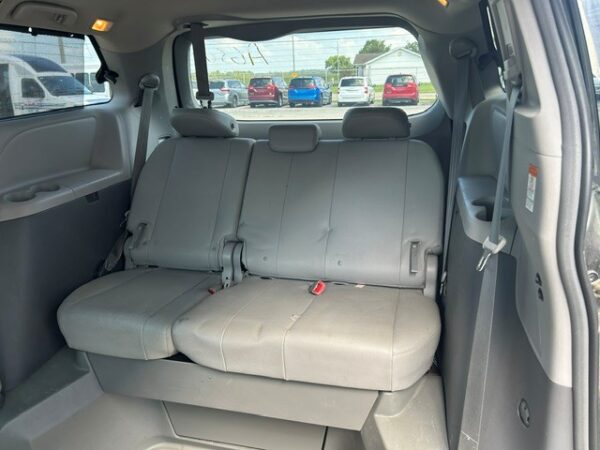 3rd row seat Gray fabric three-seat rear bench in an SUV, with headrests, viewed from the cargo area behind the seats