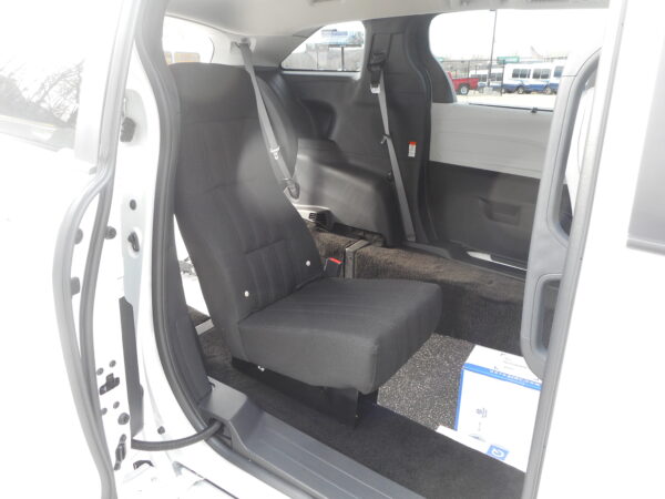 DSCN3741 Interior of a white van showing the rear bench seat with three seat belts and an open side door