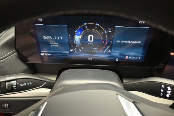 Digital car dashboard showing 0 mph in center, with a circular RPM/gear gauge, time and date on left, 'No Content Available' on right, and gear selector PRNDL at bottom right. The exterior temp reads 73°F.