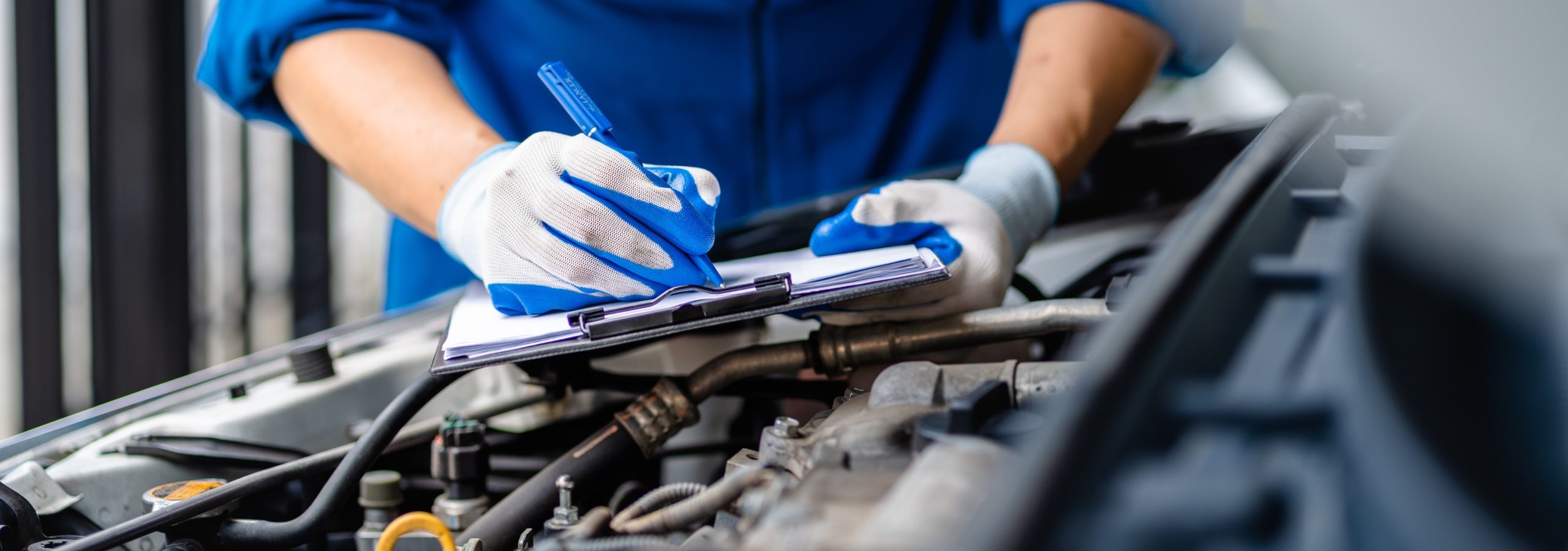 Automotive mechanic repairmen performing auto maintenance service.