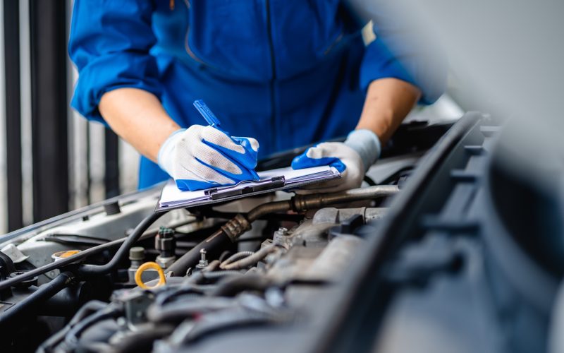 Automotive mechanic repairmen performing auto maintenance service.