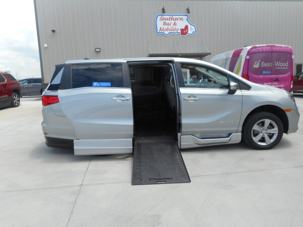 DSCN0018 Silver minivan with a deployable wheelchair ramp extended in a parking lot in front of a mobility store sign reading 'Southern Bus & Mobility'