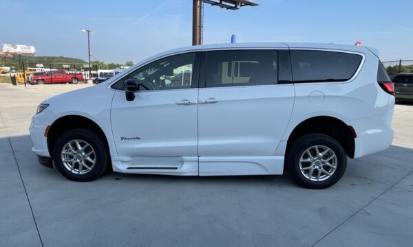 IMG_0398 White BraunAbility wheelchair-accessible minivan with lowered side entry, parked in a lot.