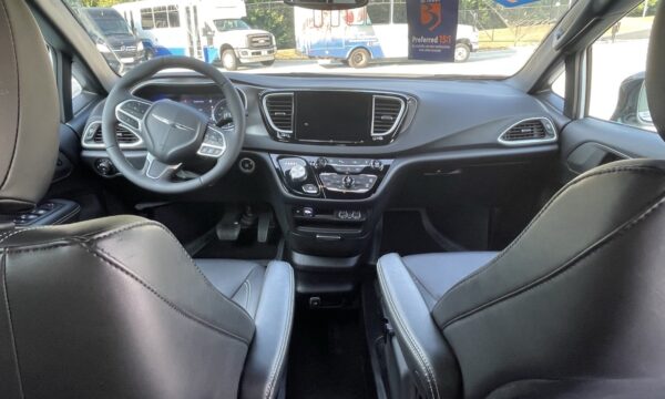 IMG_0400 Interior of a modern car showing the front seats, steering wheel, and center console with a large infotainment screen