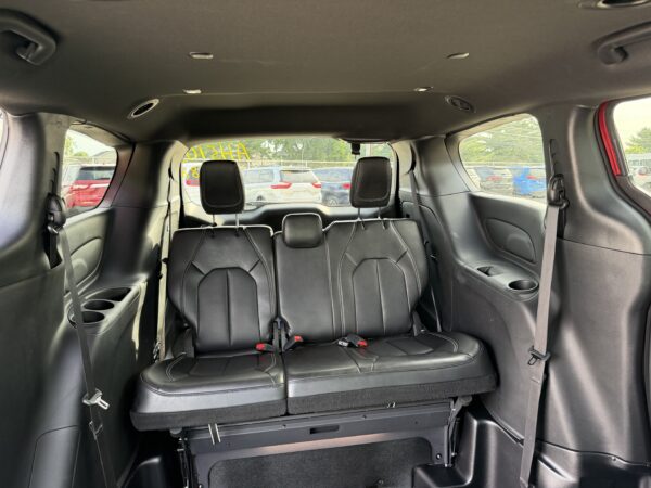 IMG_3476 Rear cargo area of an SUV with the third-row seats folded flat and black leather upholstery visible behind the front row