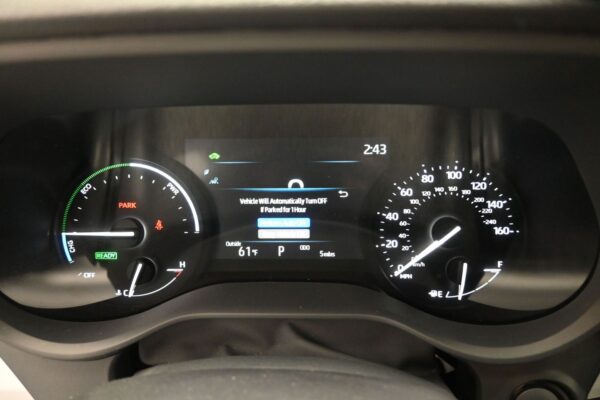 Car dashboard instrument cluster with digital central display showing time 2:43, outside temp 61°F, gear in Park, and speedometer up to 160 mph on the right; left gauge includes 'PARK' and 'READY' indicators and fuel/engine icons.