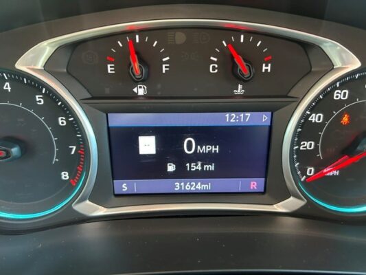 Dashboard cluster with center display showing 0 MPH, 154 mi range, and 31,624 mi on the odometer; time 12:17.