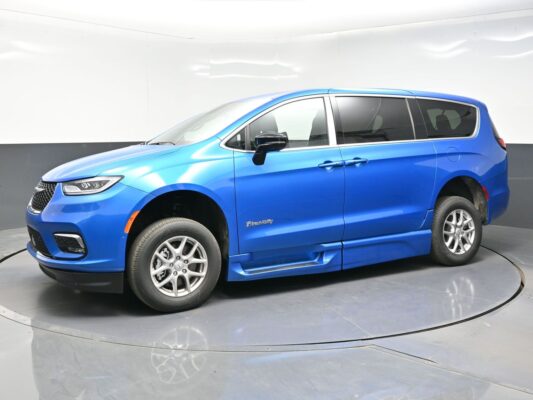 Blue BraunAbility wheelchair-accessible minivan shown in a studio setting, side view with sliding doors closed.