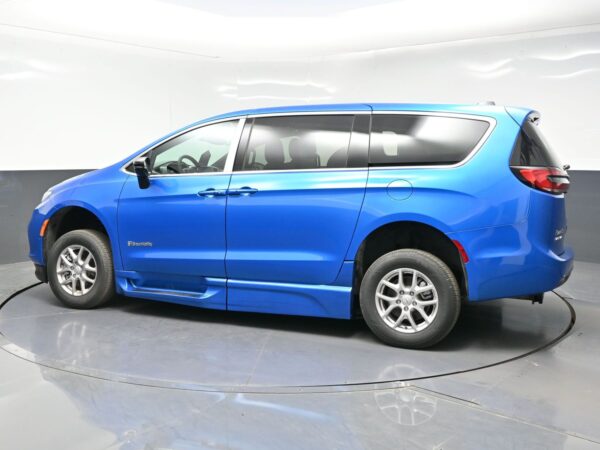 wav-2C4RC1BGXTR202255-3 Blue wheelchair-accessible minivan with BraunAbility branding, shown in a studio setting (side view).