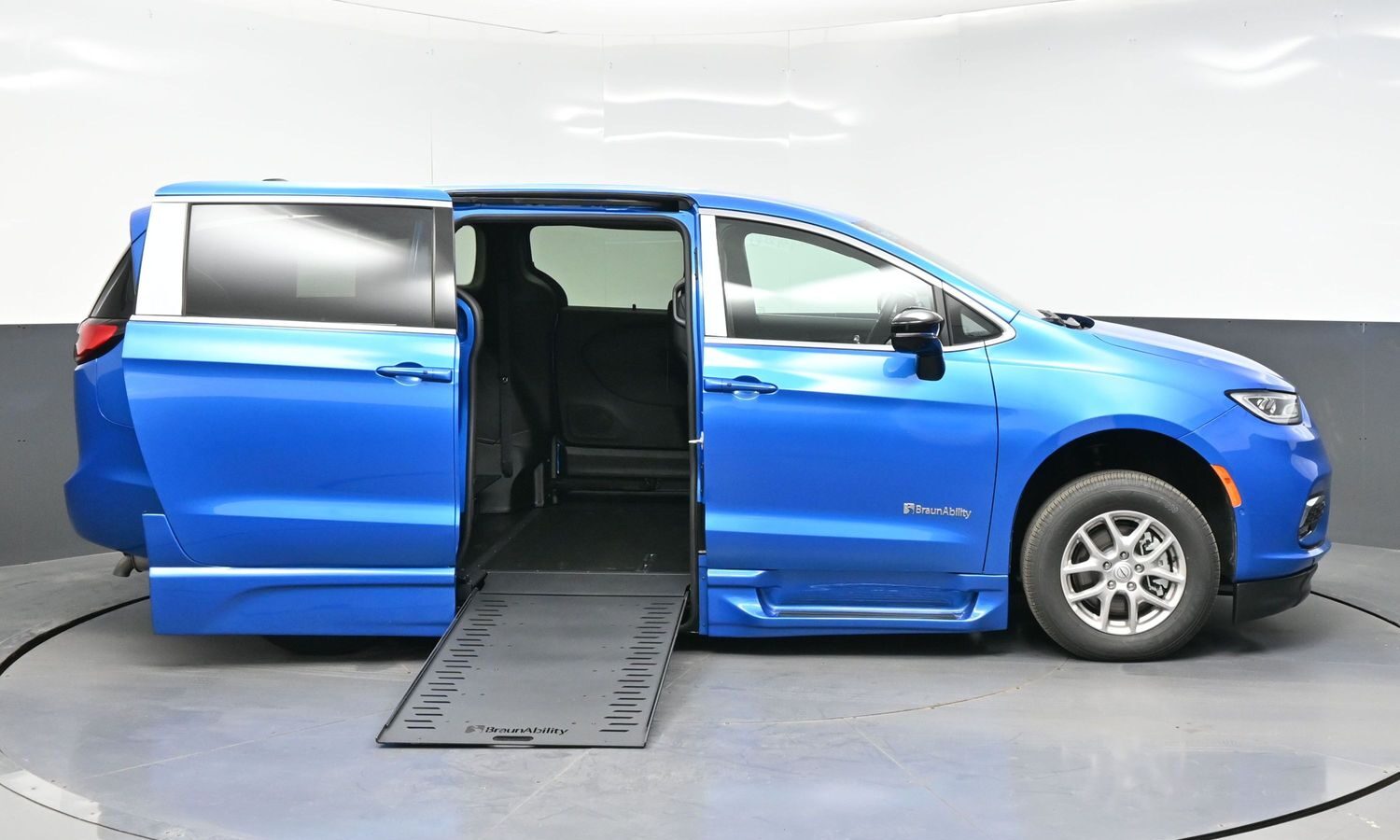 Blue BraunAbility wheelchair-accessible minivan with ramp extended for wheelchair access