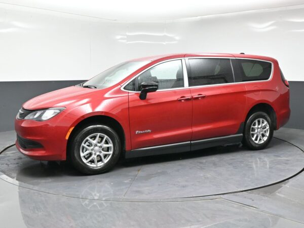 wav-2C4RC1CG9TR284610-2 Red BraunAbility wheelchair-accessible minivan shown in a studio, side view with sliding door visible
