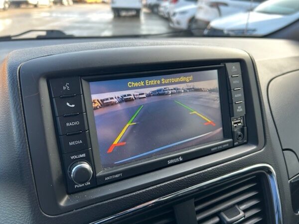 Backup camera Car rearview camera display showing parking lot with green, yellow, and red guide lines and the warning 'Check Entire Surroundings!'