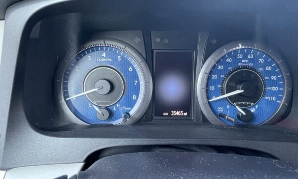 IMG_0394 Instrument cluster of a car with blue-dial gauges: tachometer on the left, speedometer on the right, and a central digital odometer reading 35,465 miles.