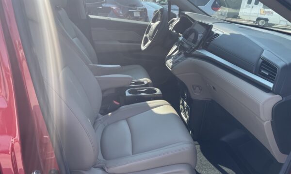 IMG_0445 Interior of a modern car from the passenger side, showing front seats, center console, and dashboard with a touchscreen.