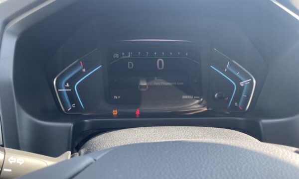 IMG_0447 Digital car dashboard: gear D, speed 0, outside temp 76°F, odometer 8,552 miles; tire pressure low warning illuminated; fuel gauge near E.