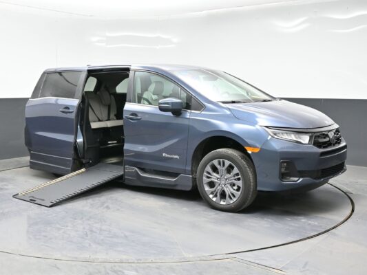 Blue SUV with both side doors open and a long ramp extending from the side, for wheelchair access.