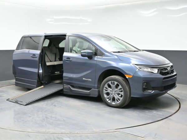 001 Blue SUV with both side doors open and a long ramp extending from the side, for wheelchair access.