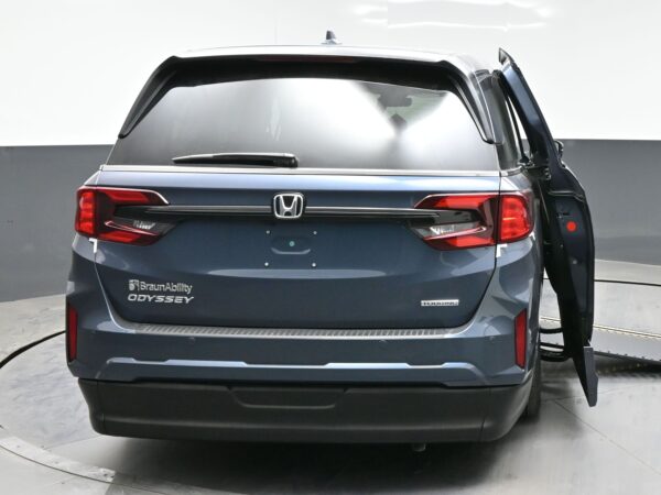 006 Rear view of a gray Honda Odyssey BraunAbility wheelchair-accessible minivan with the side-entry ramp visible on the right side piece of equipment open.