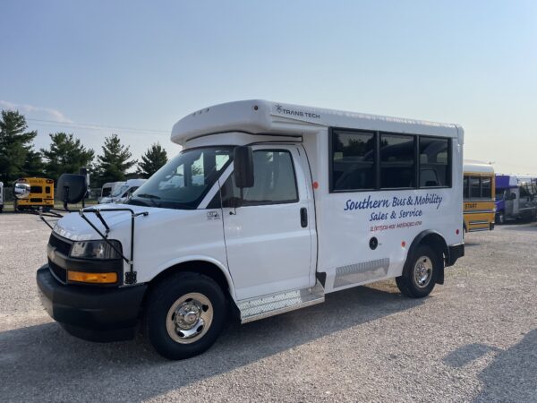 White passenger bus in a lot, with 'Southern Bus & Mobility' branding along the side and a 'Trans Tech' logo on the upper front; other buses visible in the background.