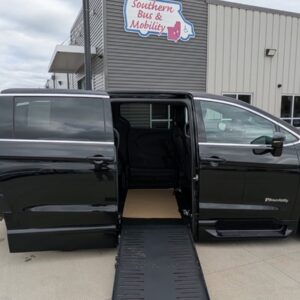 Black wheelchair-accessible van with an extended ramp, parked in front of a mobility services building labeled 'Southern Bus & Mobility'