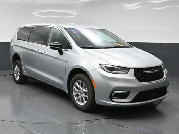 wav-2C4RC1BG3RR138911-0 Silver Chrysler Pacifica minivan in a studio showroom, viewed from the front-right side.