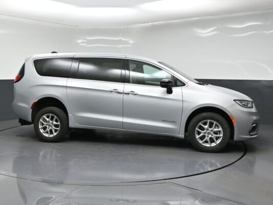 Silver BraunAbility wheelchair-accessible minivan shown from the side in a studio setting, with tinted windows and alloy wheels