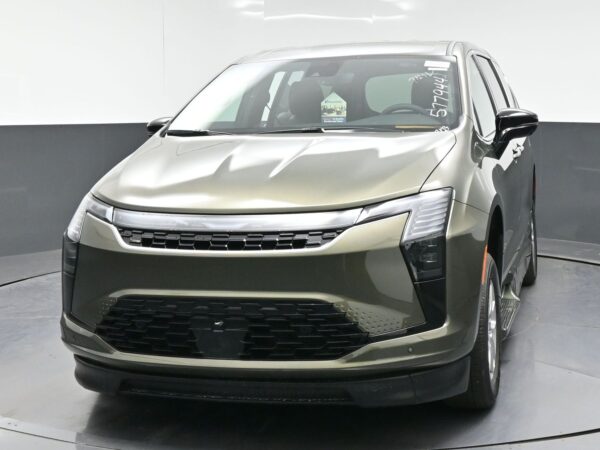 wav-2C4RC1BG7VR577944-1 Front view of a metallic beige SUV with a bold black grille and slim, angular headlights.
