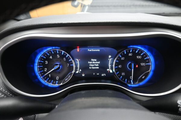 Blue backlit car dashboard showing left tachometer, right speedometer, and a central display reading 'Fuel Economy' with a 'Ramp Path Blocked' warning and guidance text.