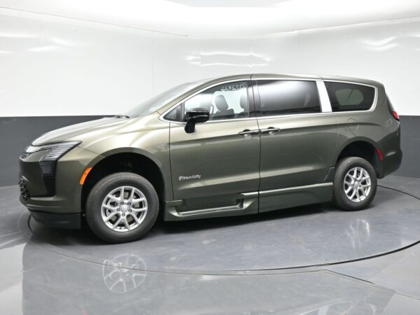 wav-2C4RC1BG7VR577944-2 Green-gray BraunAbility wheelchair-accessible minivan shown in a studio, side view with tinted windows and lowered side entry area.