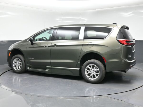 wav-2C4RC1BG7VR577944-3 Greenish-gray BraunAbility accessible minivan shown in a showroom, side view with sliding door and ramp area not visible from this angle