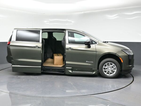 wav-2C4RC1BG7VR577944-7 Gray BraunAbility wheelchair-accessible minivan with the side door open, showing interior and a cardboard box on the floor.