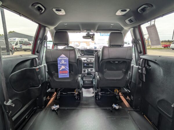 PXL_20260922_161210175 Interior of a wheelchair-accessible van with rear seats removed, revealing a flat, clear floor and wheelchair tracks along the sides.